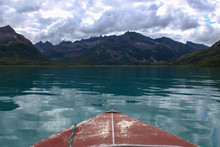 Front View From A Red Boat In Blue Lake Water Towards A Mountain View In Mirror Lake In Bristol Bay Area Of Alaska
