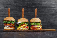 Delicious Fresh Hamburgers Served On Wooden Plank With Knife