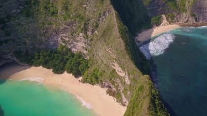 Wall Mural - Aerial back tracking on stunning tropical Paradise beach and Cliff in Nusa Penida island of Bali Indonesia in amazing beautiful coast landscape  travel destinations and holidays concept 