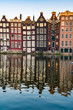 View of typical colorful Dutch houses in Amsterdam reflecting in the Amstel river canal