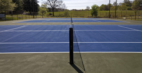 Wall Mural - Blue top tennis courts with net. Nobody.