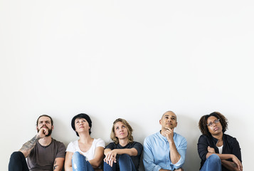 diverse people sitting with thoughtful face expression
