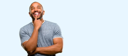 African american man with beard confident and happy with a big natural smile laughing isolated over blue background