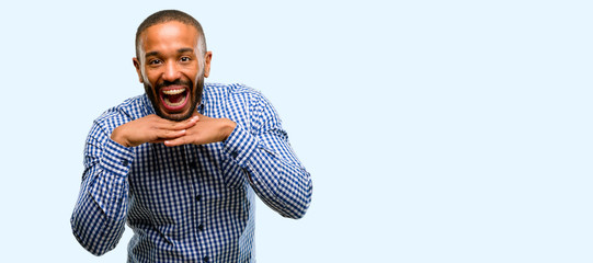 Canvas Print - African american man with beard happy and surprised cheering expressing wow gesture isolated over blue background