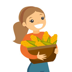 Wall Mural - A white happy woman with a basket of corncobs after corn crops harvesting in a farm field