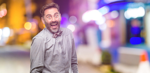 Canvas Print - Middle age man, with beard and bow tie confident and happy with a big crazy smile laughing at night club