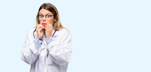 Wall Mural - Young doctor woman, medical professional terrified and nervous expressing anxiety and panic gesture, overwhelmed