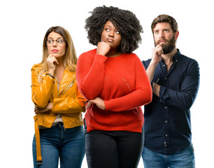 Wall Mural - Group of three young men and women thinking and looking up expressing doubt and wonder