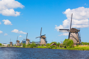 Wall Mural - Famous windmills in Kinderdijk village in Holland. Colorful spring landscape in Netherlands, Europe. UNESCO World Heritage and famous tourist site.