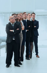 Wall Mural - professional team confidently look forward, standing in the middle of the office