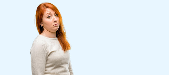 Poster - Beautiful young redhead woman having skeptical and dissatisfied look expressing Distrust, skepticism and doubt isolated over blue background