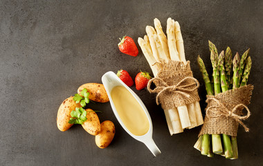 Rustic bundles of fresh green and white asparagus