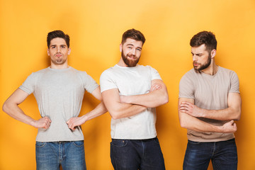 Canvas Print - Three young successful men looking at camera