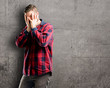 © Krakenimages.com - Young handsome man smiling having shy look peeking through her fingers, covering face with hands looking confusedly broadly