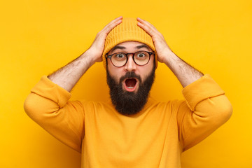 Bearded puzzled hipster in glasses