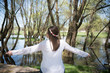 © admirdervisevi - Young woman sitting on riverbank and enjoying in nature