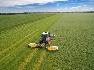 Wall Mural - 
modern tractor working on the agricultural field - tractor plowing and sowing in the agricultural field - aerial view - high top view