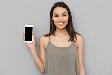 Wall Mural - Portrait of a lovely asian woman showing blank screen