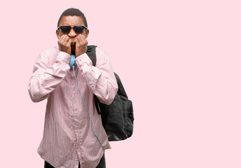 Wall Mural - African black man student terrified and nervous expressing anxiety and panic gesture, overwhelmed