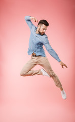 Wall Mural - Full length of a handsome young man jumping