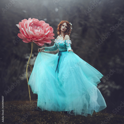A Beautiful Sensual Girl With Red Hair In A Fairy Tale Blue Dress