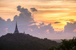 © aee_werawan - silhouette of Buddha pagoda with sunset sky