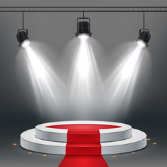 White podium and red carpet illuminated by spotlights