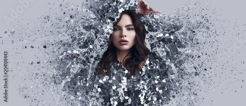 Fotografía Beautiful brunette woman in fashion dress of sequins with dispersion effect