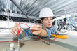 © auremar - female electrician installing of cables