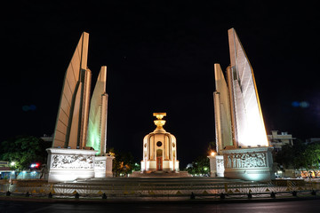 Thailand Democracy monument in the night with movement car light on street.