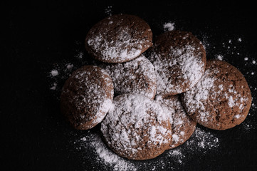 Wall Mural - oatmeal cookies on a black table in castor sugar