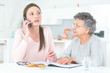 © auremar - daughter and elderly mother making a phone call