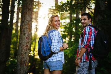 Wall Mural - couple trekking and hiking in forest