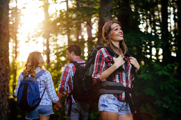 Wall Mural - group of people hiking in forest