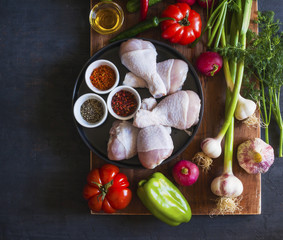 Variety of vegetables and greens for salad on a wooden Board. Top view, copy space.