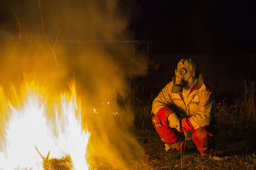 A gray gas mask on a contrasting blurred background of forest fires