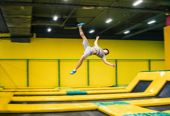 Wall Mural - trampoline jumper performs complex acrobatic exercises and somersault on the trampoline.