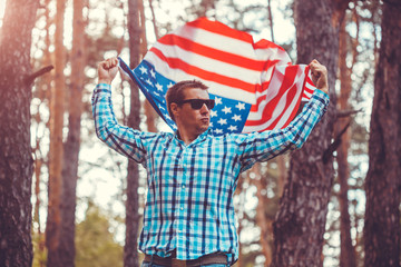 Man holding USA flag. Celebrating Independence Day of America. July 4th. Man having fun. Powerful America