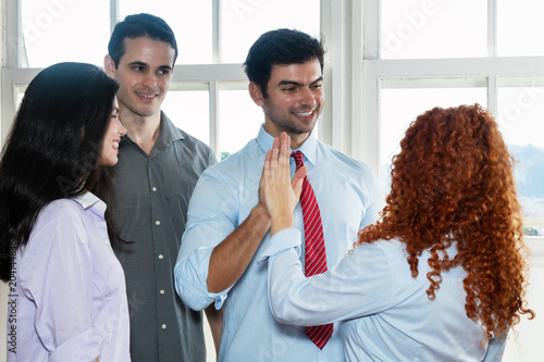 Fotografía Laughing boss giving high five to employee