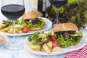 Delicious vegetarian burgers and potatoes for two. Lunch and wine. Light background and space for text