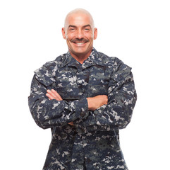 Navy man with arms crossed on white background.