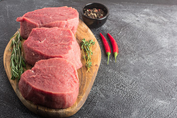 Raw beef meat on a cutting board. Close-up. Copy space