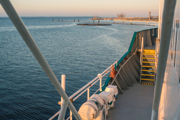 Wall Mural - Ship arrival in port. view from vessel deck. Calm sea