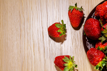 Sticker - appetizing ripe strawberries on a plate, top view, vitamin breakfast