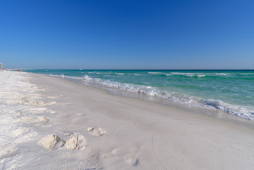 Gulf of Mexico emerald green and blue water washing on shore in waves