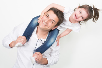 Wall Mural - Portrait of adorable girl sitting on her father back shoulder in fun play