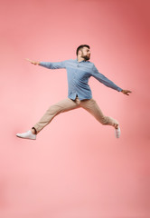 Canvas Print - Full length of a joyful young man jumping