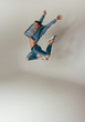 © Skripnik Olga - shot of mad, crazy, cheerful, successful, lucky guy in casual outfit, jeans, jumping with hands up,triumphant, gesturing against white background
