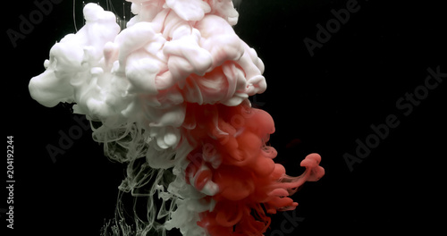 Fotomural Red and white acrylic paint cloud spraying in water on black background