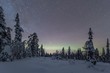 © imageBROKER - Starry sky with Milky Way and northern lights over snow-covered trees, Pyha-Luosto National Park, Lapland, Finland, Europe